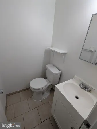 a white toilet sitting next to a bathroom sink