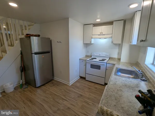 a kitchen with a stove a refrigerator and a refrigerator