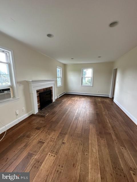21800 Peach Tree Road Dickerson, MD 20842 - Photo 4 of 18 an empty room with wooden floor fireplace and windows
