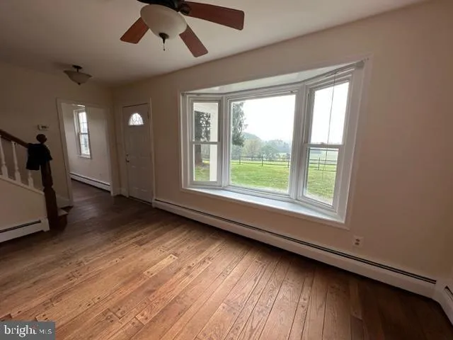 wooden floor in an empty room with a window