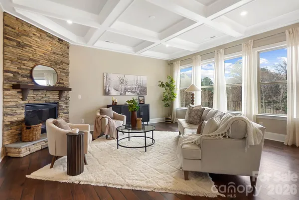 a living room with fireplace furniture and a large window