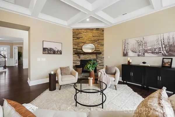 a living room with furniture a window and wooden floor