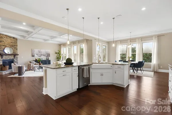 a kitchen with a wooden floor window and chairs