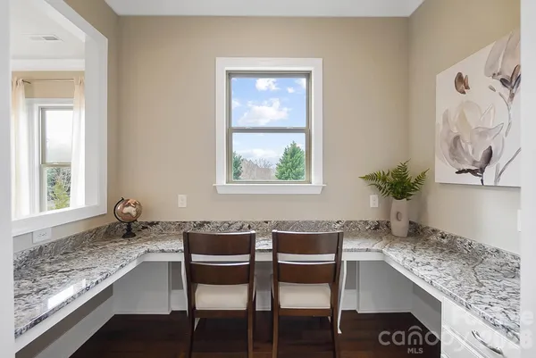 a dining room with table chairs and window
