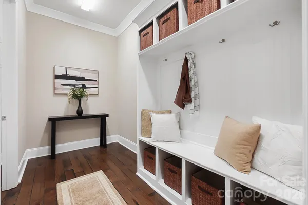 a bedroom with furniture and wooden floor