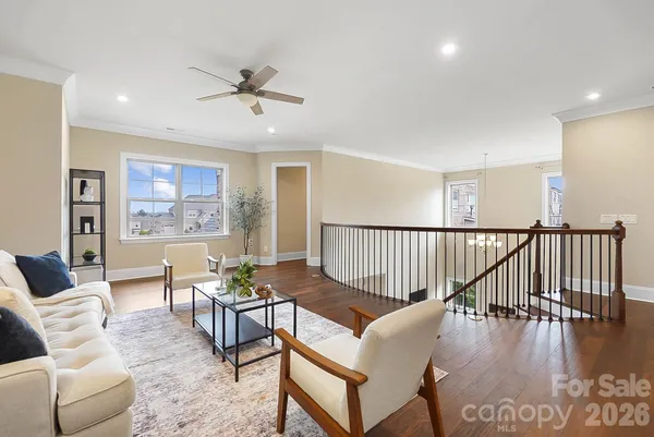 a living room with furniture wooden floor and a window