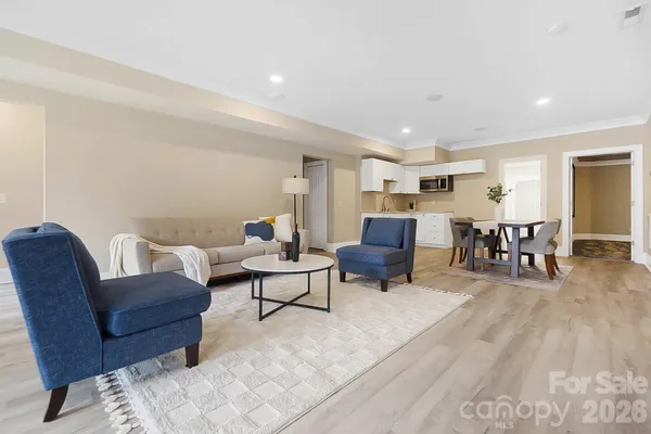 a living room with furniture and wooden floor