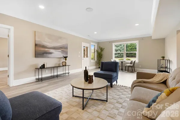 a living room with furniture and a potted plant