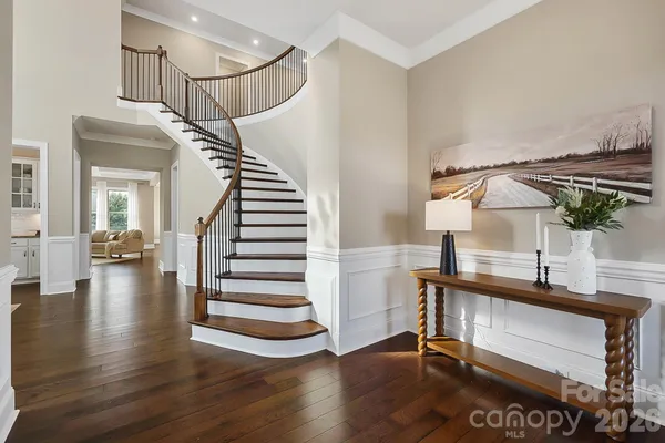 a view of entryway and hall with wooden floor