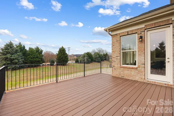 a view of a house with a wooden deck