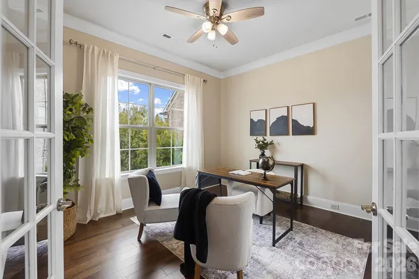 a view of a workspace with furniture and a window