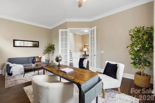 a living room with furniture potted plant and a window