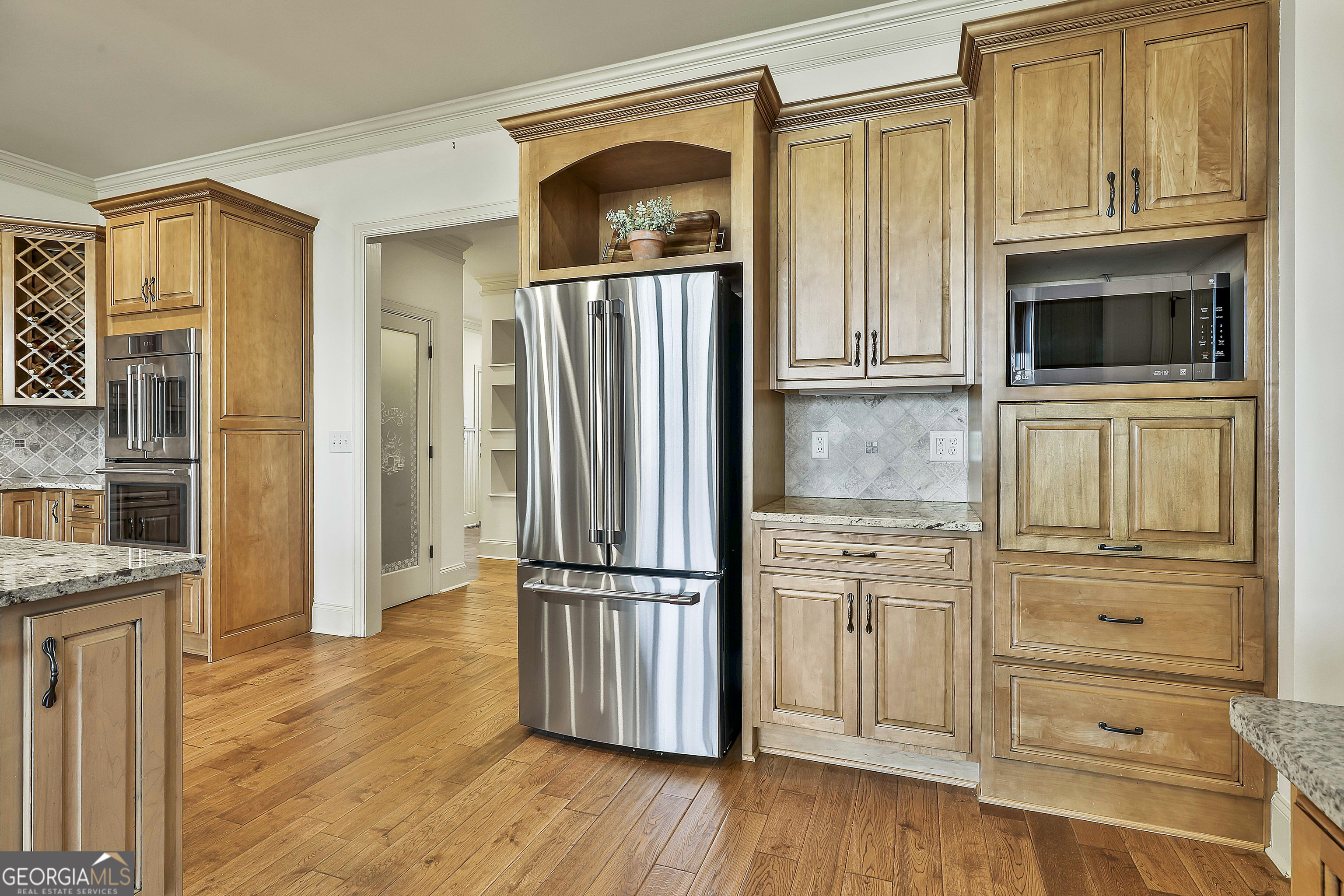 35 Fern Leaf Way Newnan, GA 30265 - Photo 34 of 112 a kitchen with stainless steel appliances granite countertop a refrigerator and a stove top oven