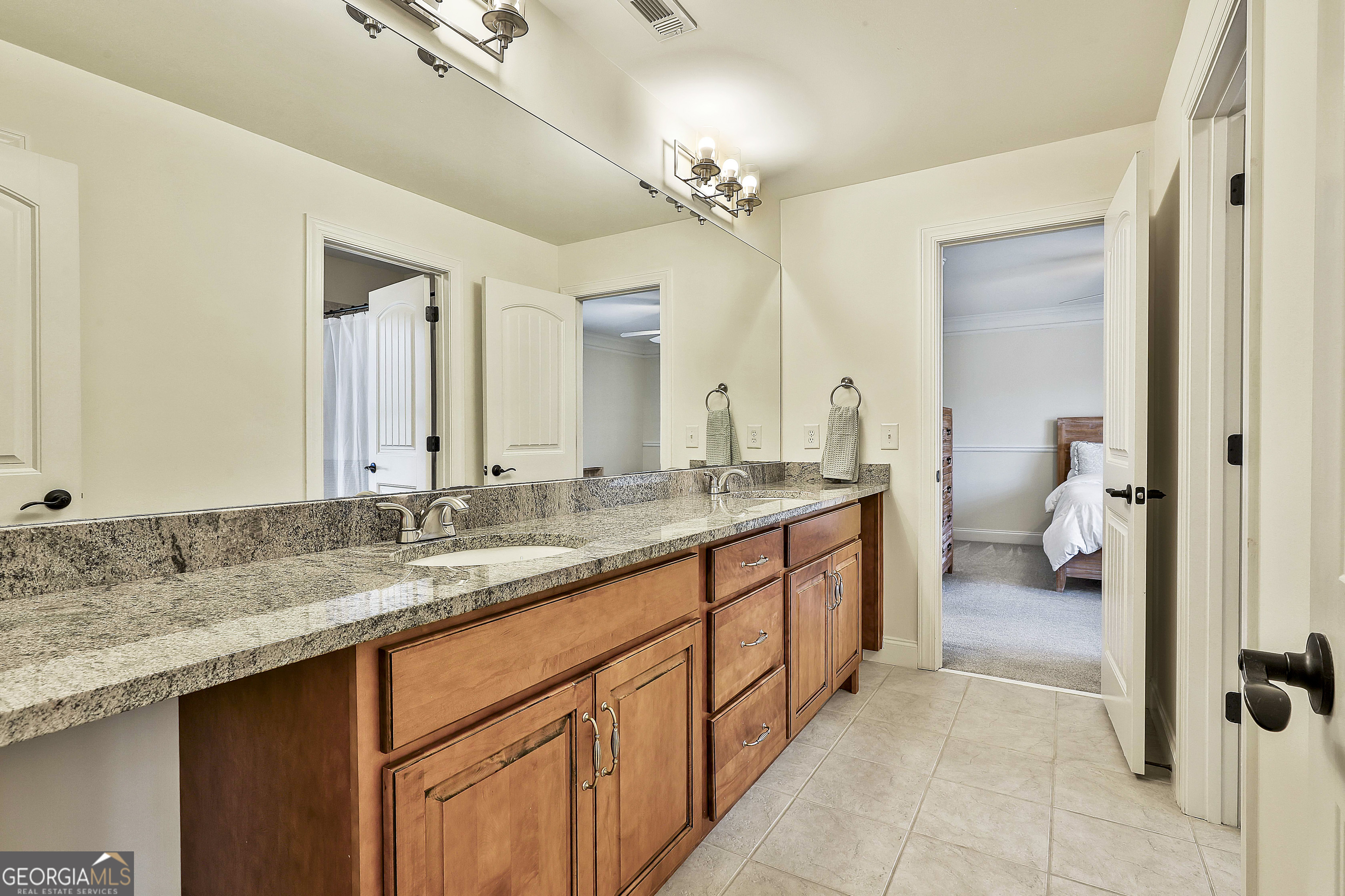 35 Fern Leaf Way Newnan, GA 30265 - Photo 65 of 112 a spacious bathroom with a granite countertop sink a toilet and a mirror