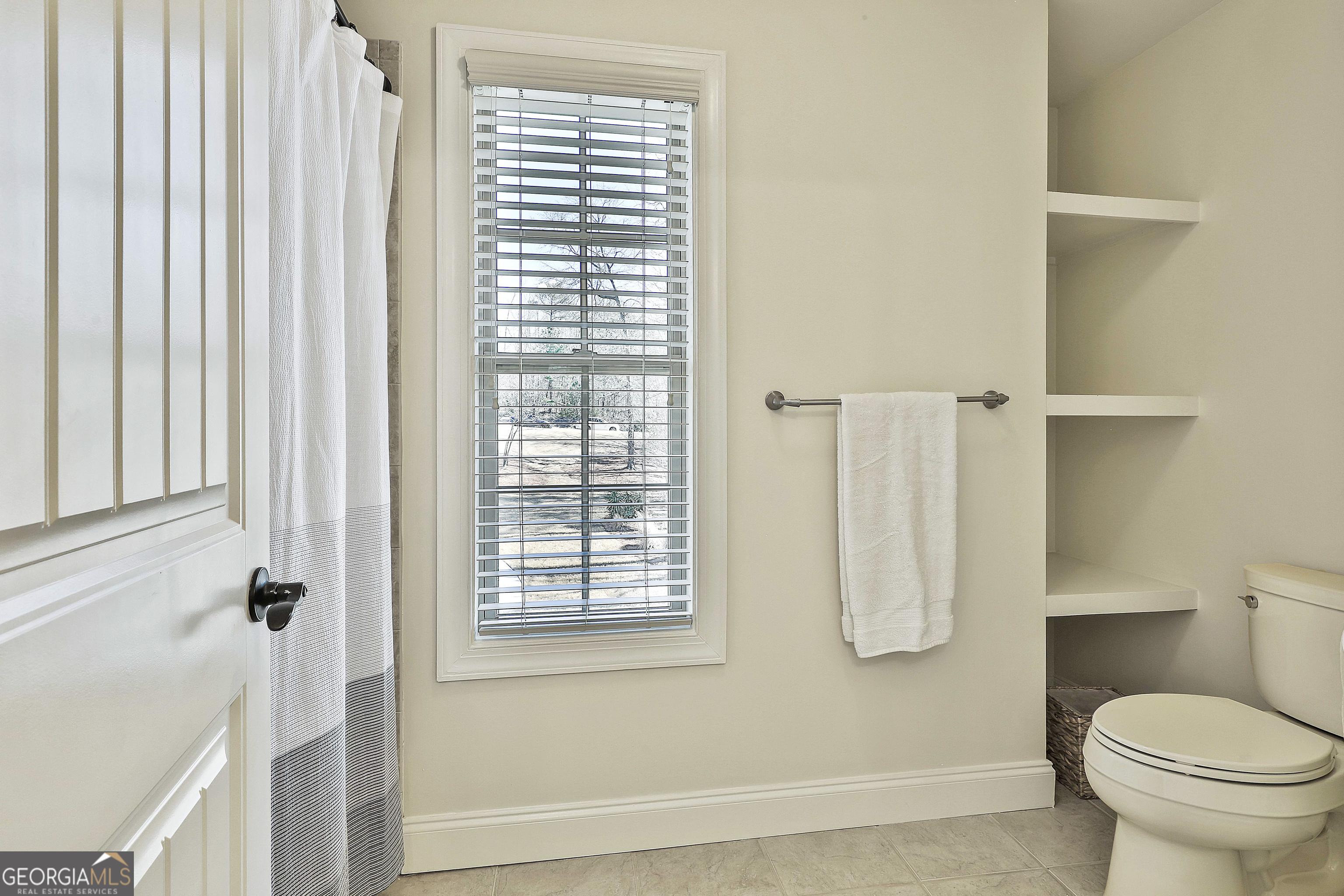 35 Fern Leaf Way Newnan, GA 30265 - Photo 66 of 112 a bathroom with a toilet and a shower curtain