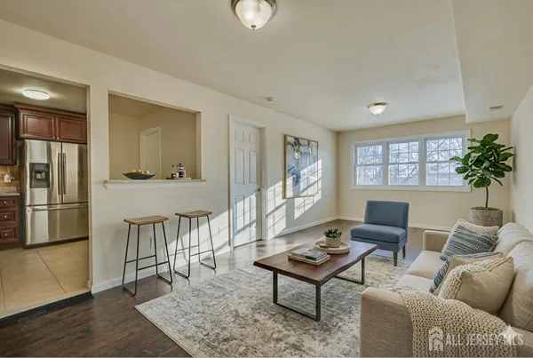 a living room with furniture a lamp a rug and a window