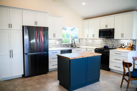 a kitchen with a sink stove and refrigerator