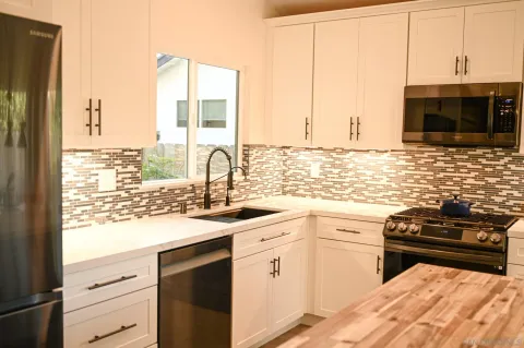 a kitchen with a sink stove and cabinets