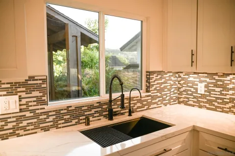 a kitchen with a sink and large window