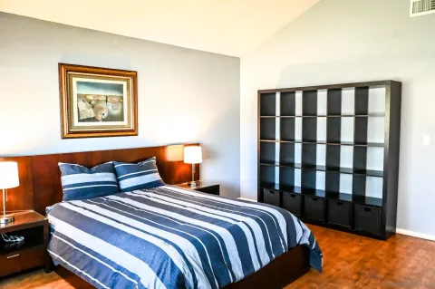 a bedroom with bed and a window