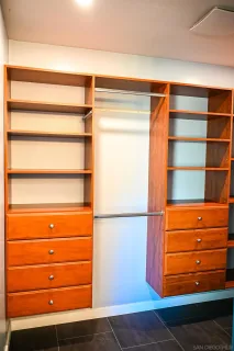a view of walk in closet with empty racks