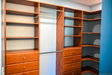 a view of walk in closet with empty racks