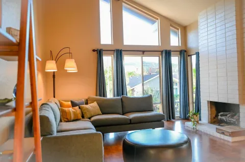 a living room with furniture and a large window