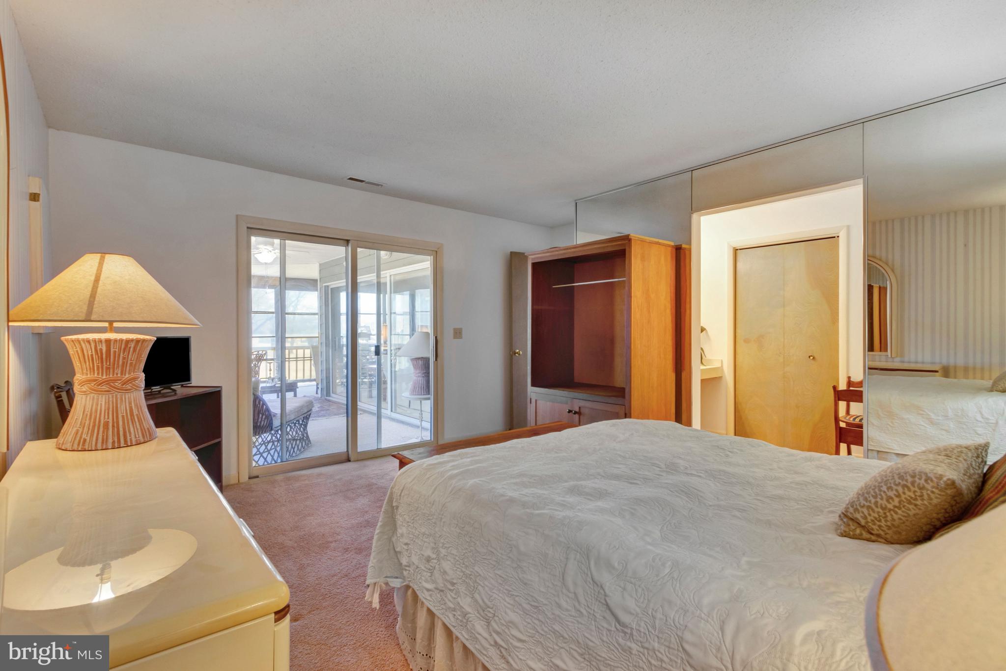 18540 Drayton Hall Road, Unit 6 Lewes, DE 19958 - Photo 31 of 37 Primary bedroom opens to 3 season porch