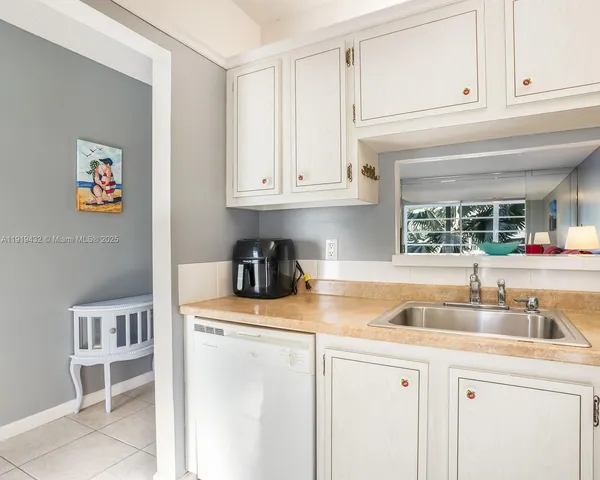 a kitchen with appliances cabinets and a sink