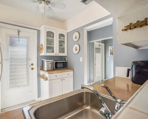 a kitchen with a refrigerator and a sink