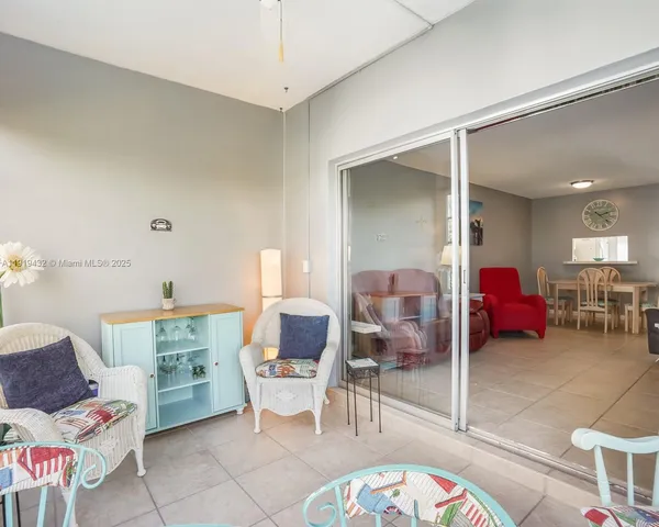 a living room with furniture and a lamp