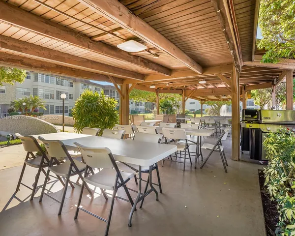 a view of an outdoor dining space with a table and chairs