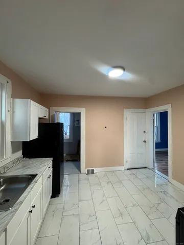 a kitchen with a refrigerator and a sink