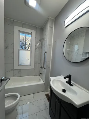 a bathroom with a sink a toilet and a bathtub