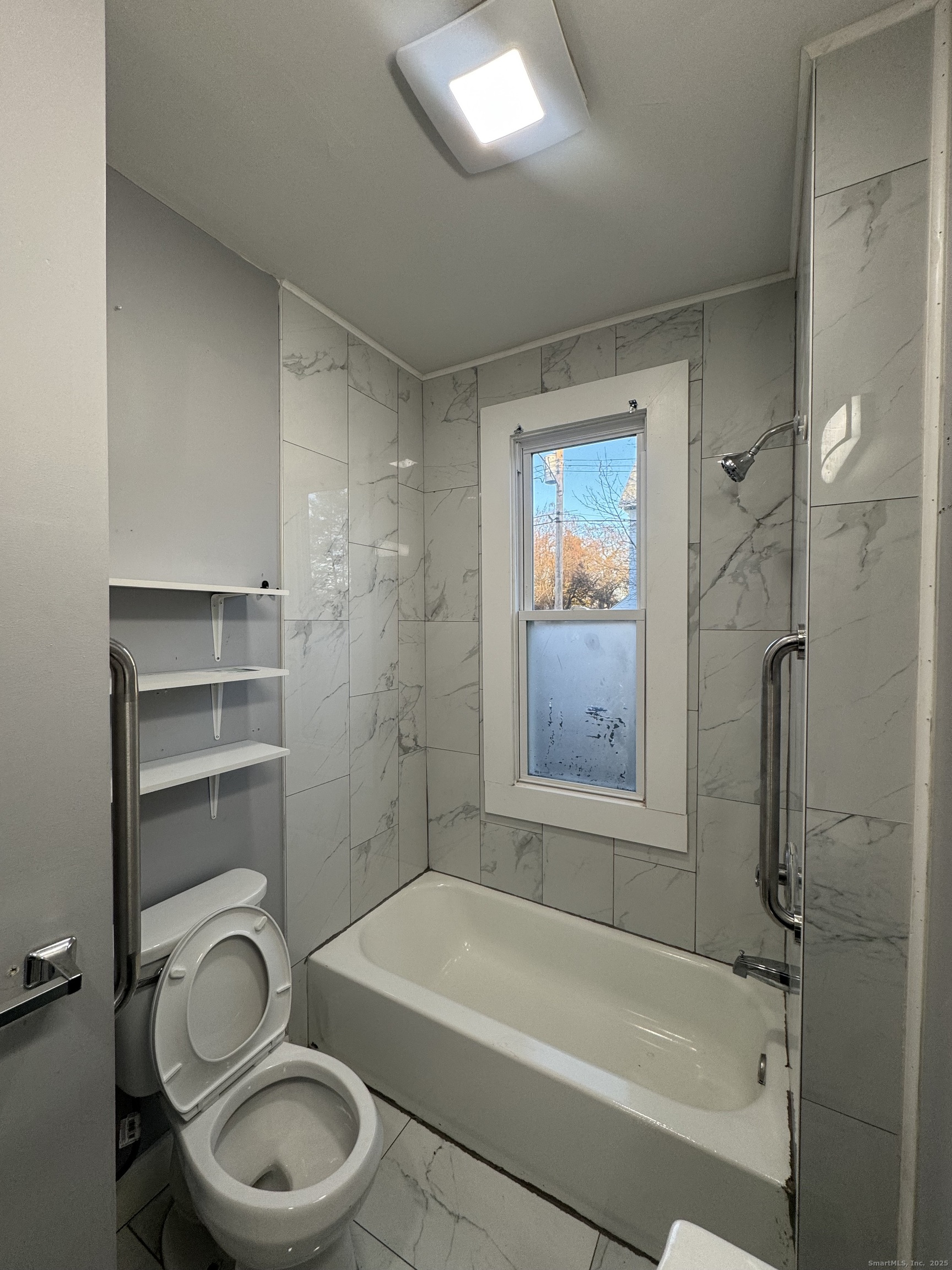 199 English Street, Unit 1 New Haven, CT 06513 - Photo 4 of 10 a bathroom with a granite countertop toilet a sink and bathtub