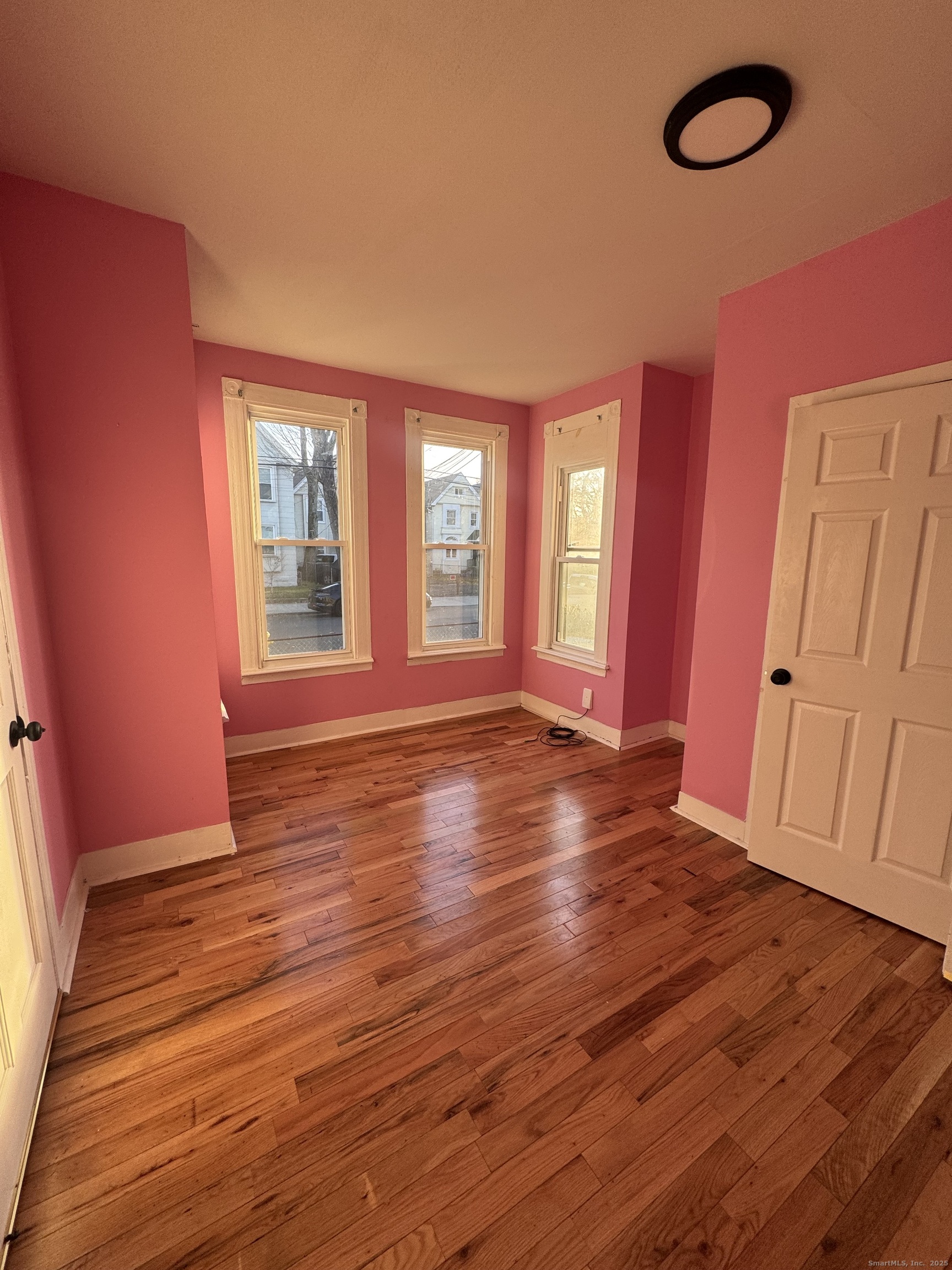 199 English Street, Unit 1 New Haven, CT 06513 - Photo 7 of 10 an empty room with wooden floor and windows
