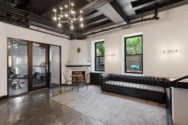 a spacious bedroom with a bed and a chandelier