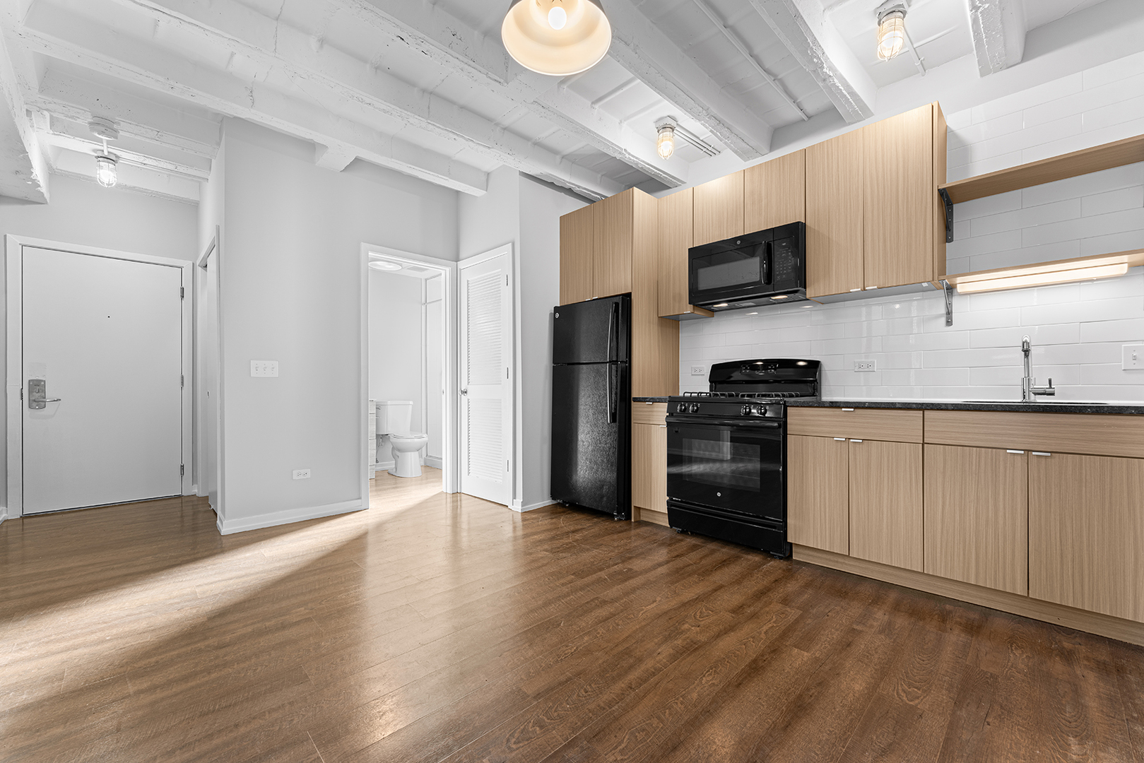 5718 North Winthrop Avenue, Unit 612 Chicago, IL 60660 - Photo 4 of 16 a kitchen with stainless steel appliances a refrigerator and a stove top oven