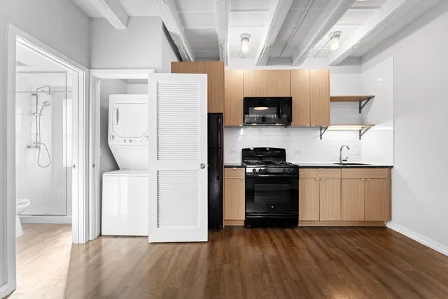 a kitchen with a refrigerator and a stove top oven