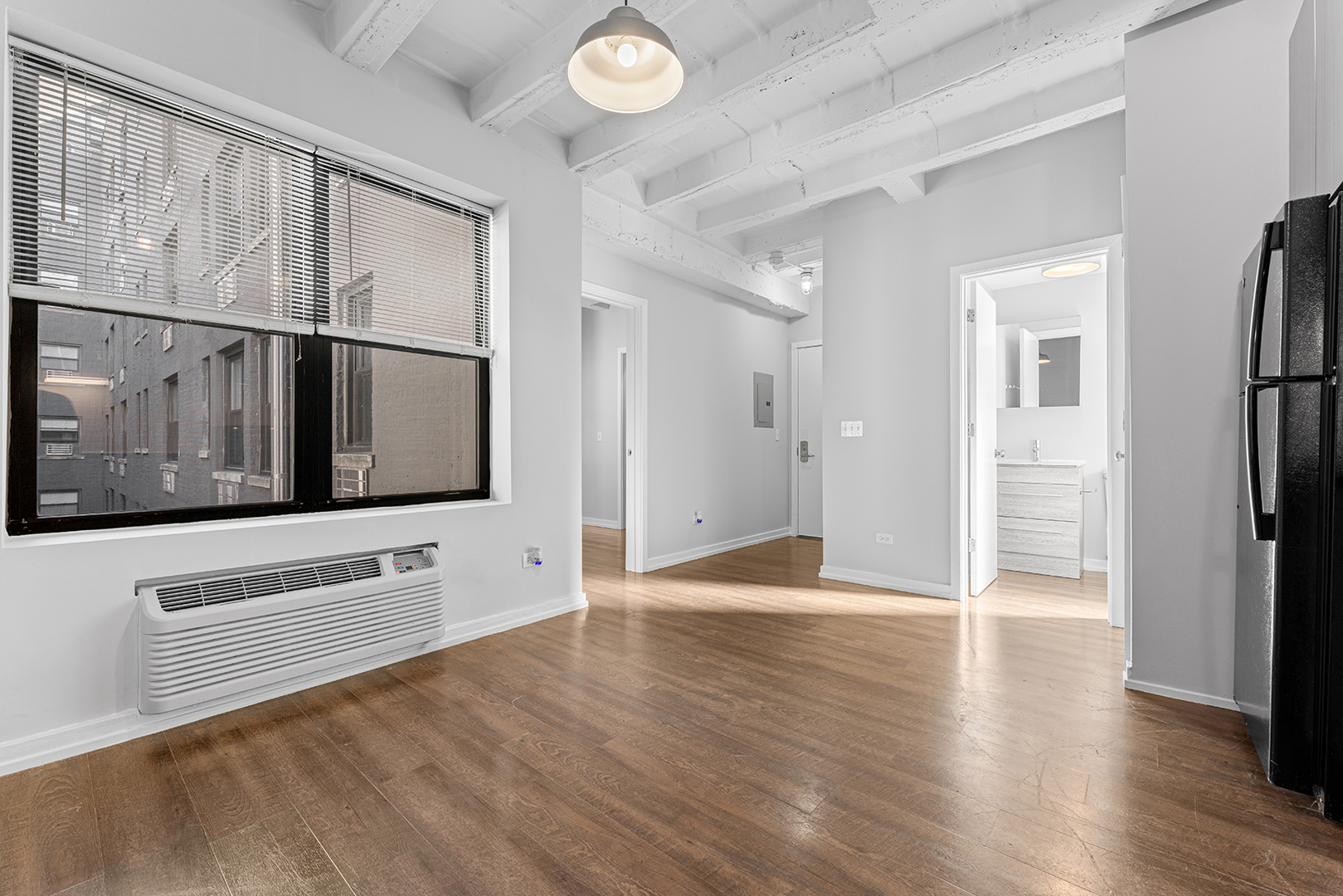 5718 North Winthrop Avenue, Unit 612 Chicago, IL 60660 - Photo 7 of 16 a view of an empty room with wooden floor and a window