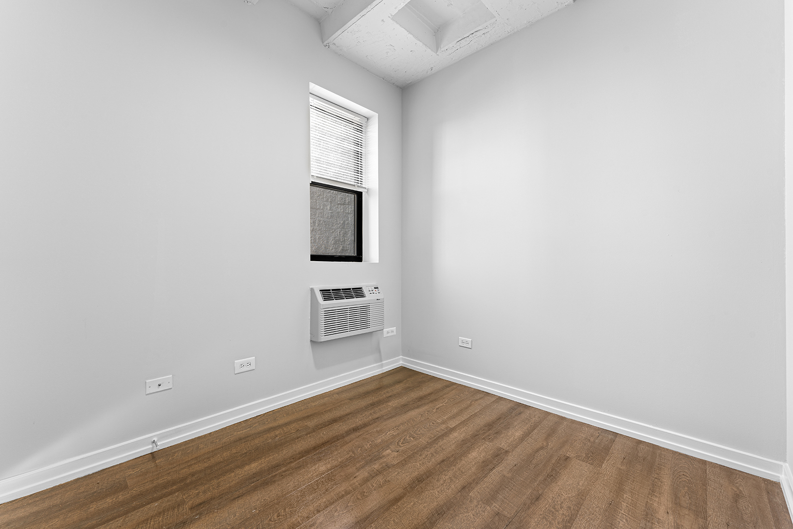 5718 North Winthrop Avenue, Unit 612 Chicago, IL 60660 - Photo 8 of 16 a view of a room with wooden floor and white walls