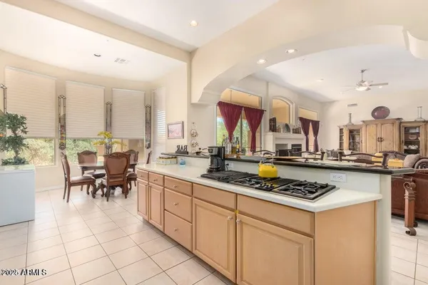 a kitchen with stainless steel appliances a stove a sink dishwasher and white cabinets with wooden floor