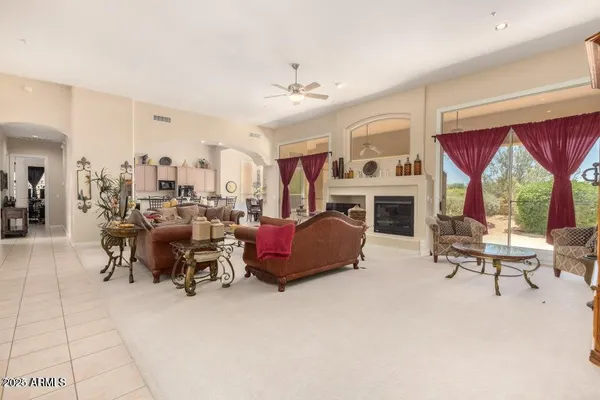 a living room with furniture large window and a fireplace