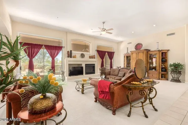 a living room with furniture a rug and a flat screen tv