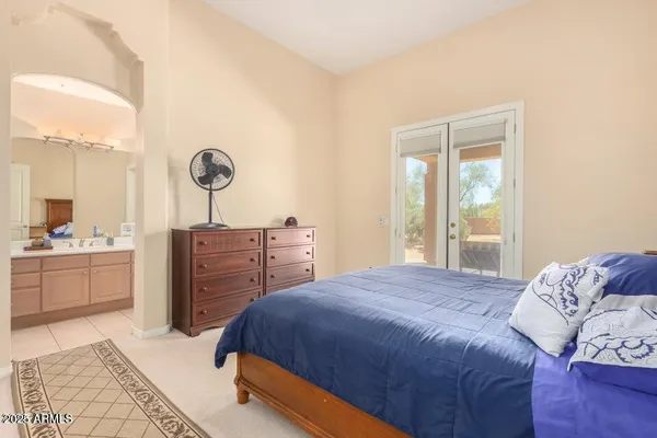 a bedroom with a bed a dresser and chair