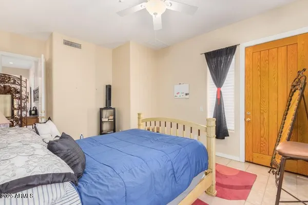 a bedroom with a bed and a chandelier