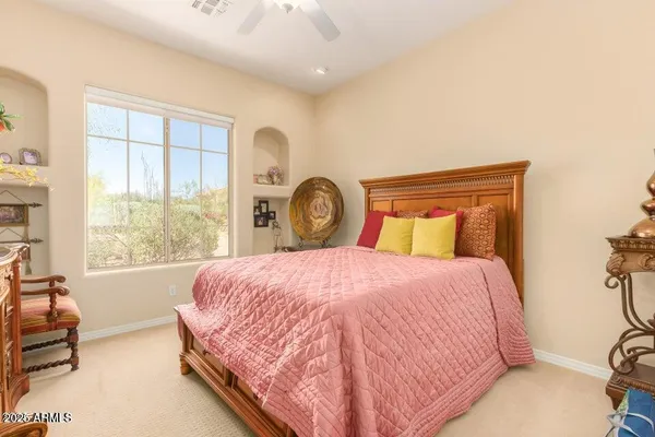 a bedroom with a bed and a large window