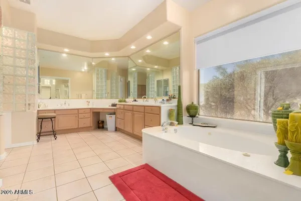 a large white kitchen with a large window