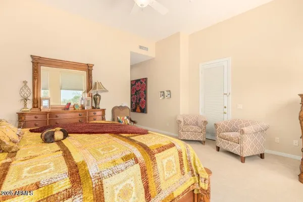 a spacious bedroom with two beds and large windows