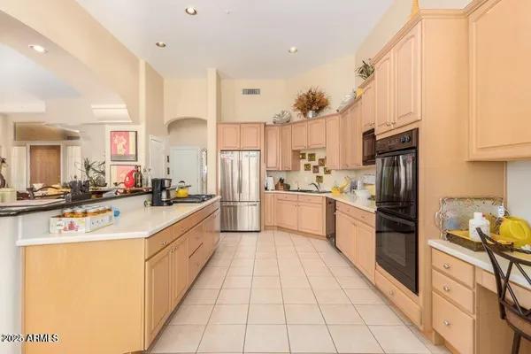 a kitchen with stainless steel appliances and white cabinets